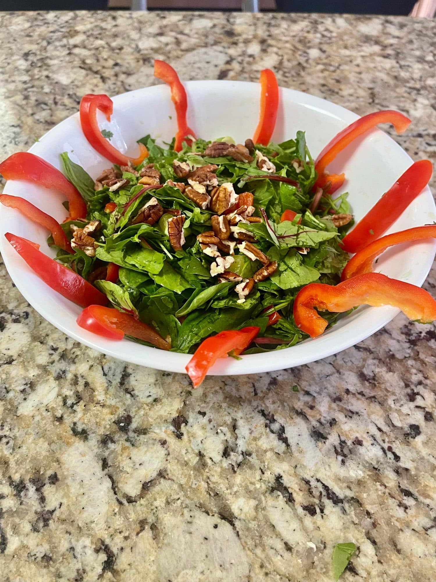Fresh arugula salad with red peppers and pecans