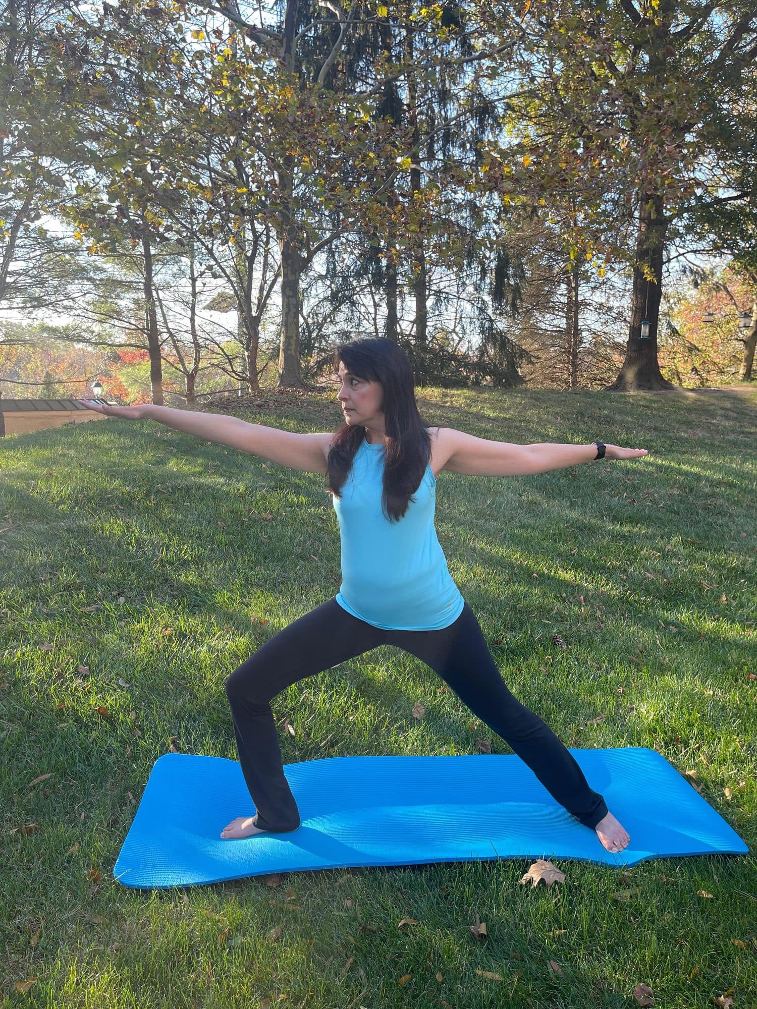 Misha in Warrior II pose outdoors